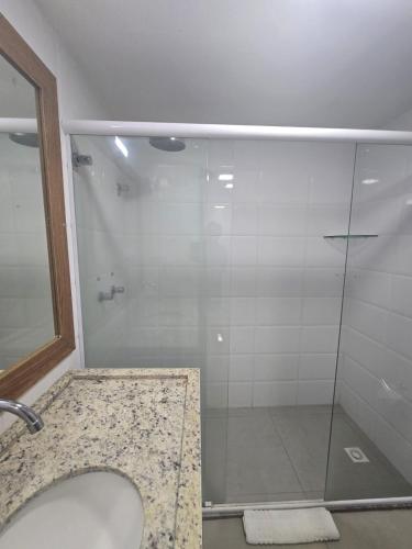 a bathroom with a shower with a glass door at Hotel Imperial Flat in João Pessoa