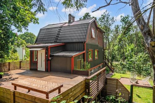 a small house with a wooden deck and a table at the Little Oasis In Gothenburg in Gothenburg