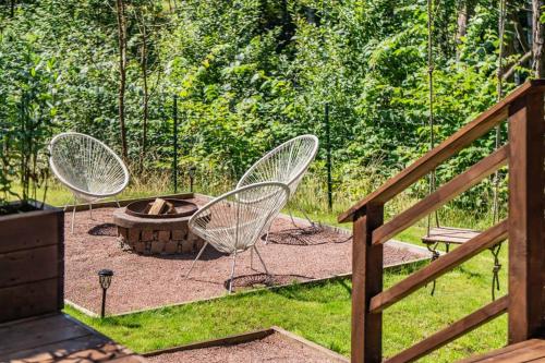 two chairs and a fire pit in a yard at the Little Oasis In Gothenburg in Gothenburg