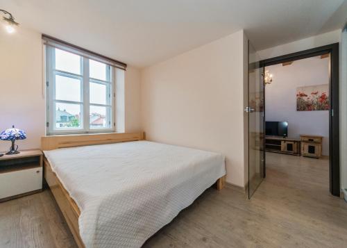 Ένα ή περισσότερα κρεβάτια σε δωμάτιο στο Bielsko Apartments