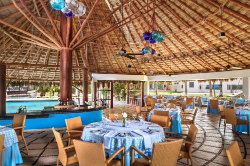 a banquet hall with tables and chairs and a pool at Sunscape Dorado Pacifico Ixtapa Resort & Spa- All Inclusive in Ixtapa
