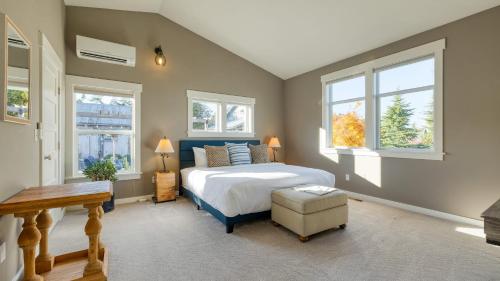 a bedroom with a bed and two windows at 3-Home Coastal Retreat w Sauna Firepit Greenhouse Seabright Haven by AvantStay in Coupeville