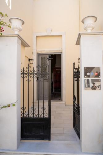 an entrance to a house with a black gate at The Saints Inn & Spa in Athens