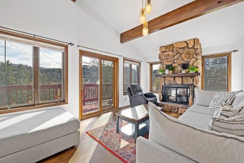 a living room with a couch and a fireplace at Lead Haven Lodge in Lead