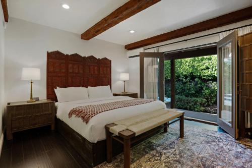 a bedroom with a large bed and a large window at Talavera Palm Springs in Palm Springs