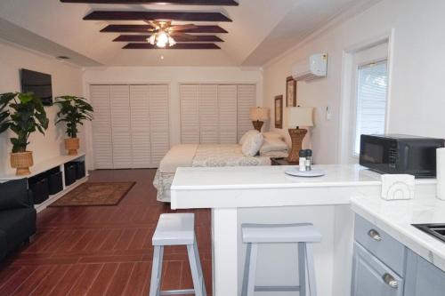a kitchen and living room with a bed in the background at Lakeland Suites in Lakeland