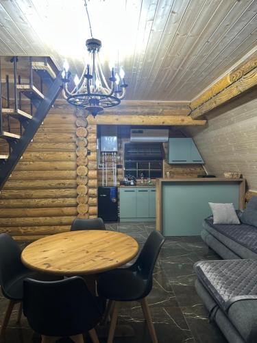 a living room with a table and a couch at Borjomi-sadgeri comfort in Borjomi