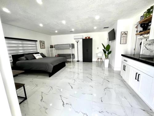 a bedroom with a bed and a marble floor at Lovely and Private Studio