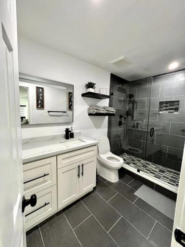 a bathroom with a sink and a toilet and a shower at Lovely and Private Studio