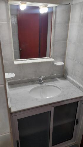 une salle de bain avec un lavabo et un miroir dans l'établissement La casa del pino, à Mina Clavero