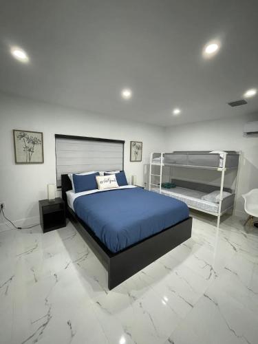 a bedroom with a large bed with a blue blanket at Lovely and Private Studio
