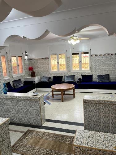 a living room with couches and a table at Villa Haryouli in Azemmour