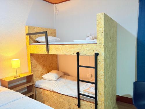 a room with bunk beds with a bed and a lamp at Casa Azucena in Flores