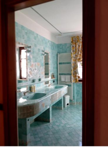 a bathroom with a large sink and a tub at Family rooms with full kitchen in Lake Garda in Cavalcaselle