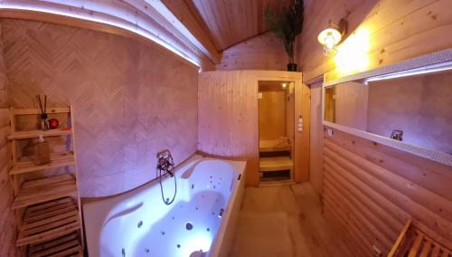 a large bathroom with a bath tub in a room at Chalet Vito - Where Luxury Meets Tranquility in Gregurić Breg