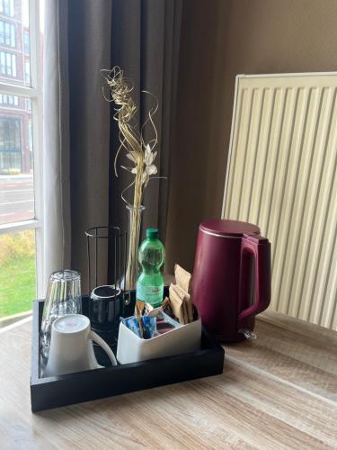 a tray with a coffee maker and a flower on a table at Room in the center of Enschede in Enschede