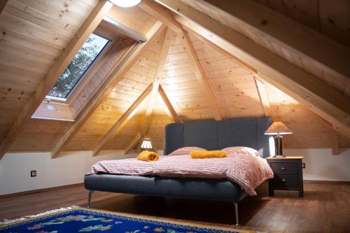 a bedroom with a bed in a attic at Balaton Cottage - Your Hide Away in Cserszegtomaj