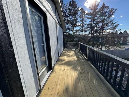 a balcony with a window on the side of a house at Empire Extended Stay in Webster