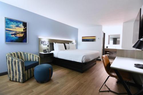 a hotel room with a bed and a desk at Best Western Point South in Yemassee