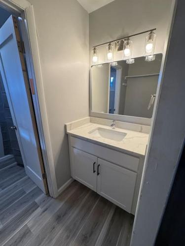 a bathroom with a sink and a mirror at Empire Extended Stay in Webster