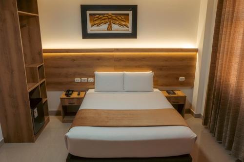 a hotel room with a bed and two night stands at Antawa Hotel in Moquegua