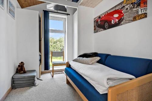 a living room with a blue couch and a window at N334-Karrebaeksminde-Reedtzholmvej-127 in Enø By