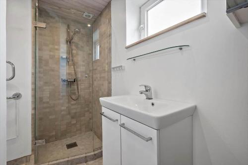 a white bathroom with a sink and a shower at N334-Karrebaeksminde-Reedtzholmvej-127 in Enø By