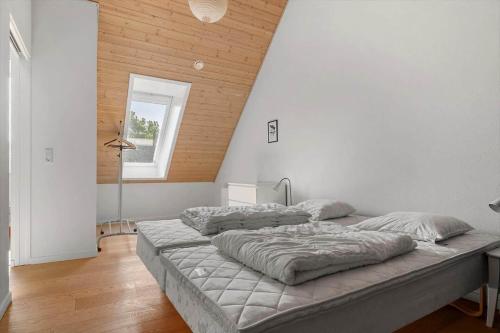 a bedroom with a large bed with two pillows at 20424-Samso-Besser-Kirkevej-4-C in Langemark