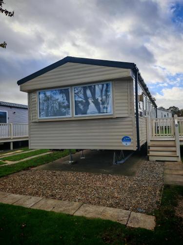 a tiny house with a large window in a yard at Primrose Valley Primrose field 4 in Filey