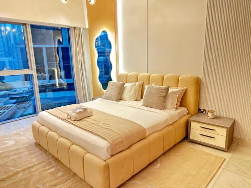 a large bed in a room with a large window at Central Park towers residence difc in Dubai