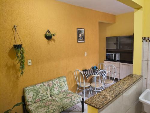 a kitchen with a counter and a table and chairs at Kitinet Verolme AFP 1 in Angra dos Reis