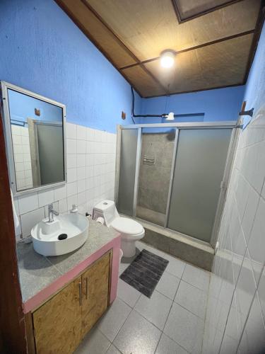 a bathroom with a sink and a toilet at Casa Azucena in Flores