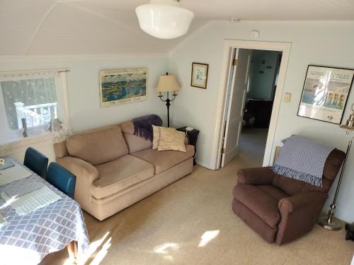 a living room with a couch and a chair at Bay Cottage Getaway in Port Townsend