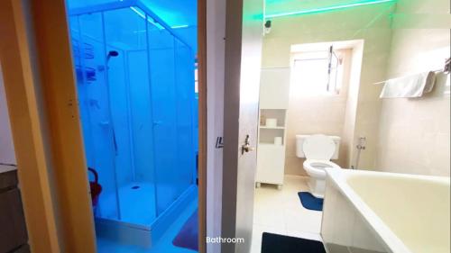 a bathroom with a tub and a toilet and a shower at Sams Rooms - Solo Female Guest House in Amadora