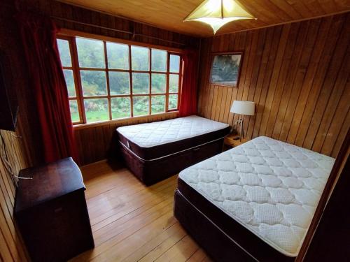 Postel nebo postele na pokoji v ubytování Lodge Laguna escondida