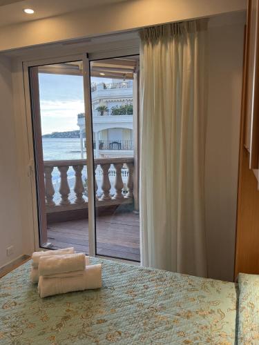 a bedroom with a bed with a view of the ocean at Lisa Apartment in Menton