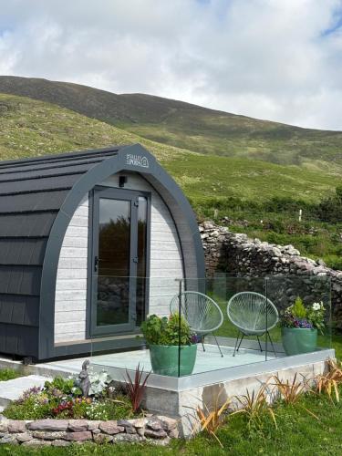 a small building with two chairs and a table at LUXURY POD - Hidden Hills Waterville Farm in Waterville
