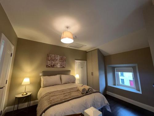 a small bedroom with a bed and a window at The Corner house, Dromod in Leitrim