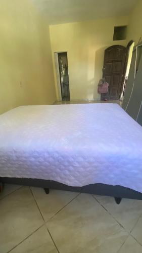 a large bed sitting in a room with at Espaço de Iguaba Grande in Iguaba Grande