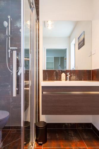 a bathroom with a sink and a shower at Halswell Quarry - Walk and Explore - 3 bed in Christchurch