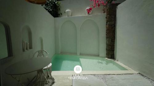 a bathroom with a tub and a sink at CasaIvan in Florianópolis