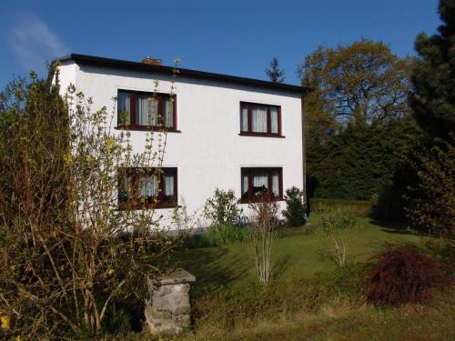 オストゼーバート・カールスハーゲンにあるUns Oellernhuusの緑の野原に建つ窓のある白い家