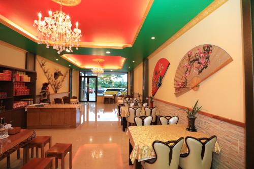 a restaurant with a table and chairs and a chandelier at Sun Moon Lake Tan Hsiang Yu B&B in Yuchi