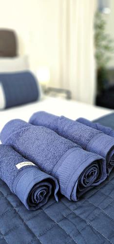 a pile of purple towels sitting on top of a bed at Copacabana Vibes Studios in Rio de Janeiro