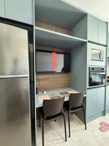 a small kitchen with a table and two chairs at Apartamento na Praia dos Carneiros a 250m do mar in Tamandaré