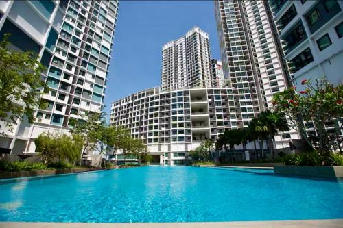 a swimming pool in the middle of two tall buildings at Spacious 2-Storey & Connected Home Link Central i-City in Shah Alam