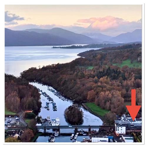 an aerial view of a river with a bridge at Riverside View Apartment in Balloch, Loch Lomond in Balloch