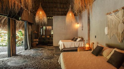 a hotel room with two beds and a living room at Saccharum in Nocaima