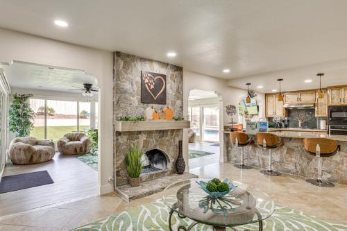 a living room with a fireplace and a kitchen at Luxe Family Home in Bonita with Private Pool and Spa! in Bonita