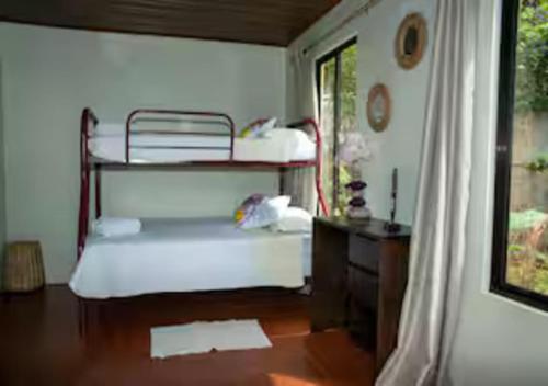 a room with two bunk beds and a window at Paradise Views Awaits, King Bed, Hot-Tub in Quebradas